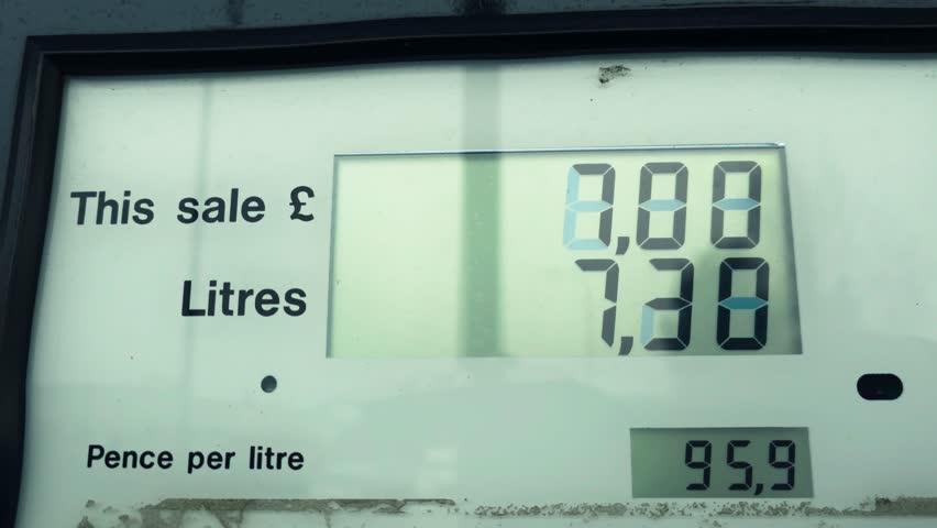 Fuel station counter calculating price in pounds. Gas pump display measuring litres and cost during global fuel crisis. Digital meter reflecting rising energy expenses in currency format