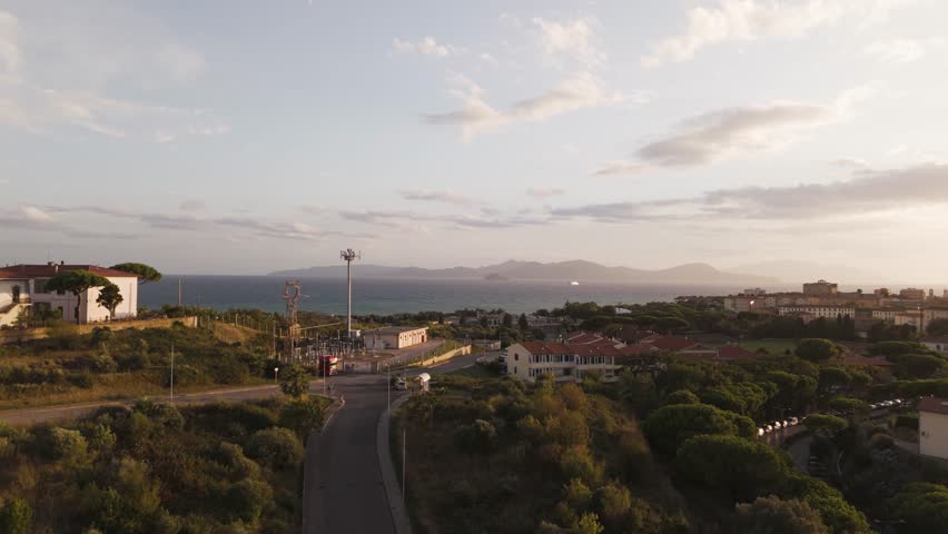 Drone view over Piombino, a coastal town in Tuscany, highlighting rooftops, coastline, roads, and Mediterranean surroundings. Excellent for tourism and regional storytelling.