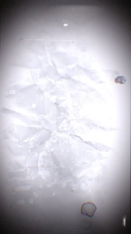 A looping background of stop motion style love grungy paper love hearts in a stylised negative film reel style.
