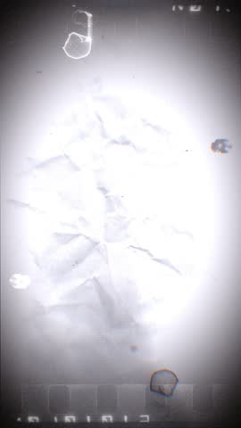 A looping background of stop motion style love grungy paper love hearts in a stylised negative film reel style.
