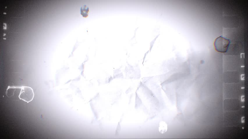 A looping background of stop motion style love grungy paper love hearts in a stylised negative film reel style.
