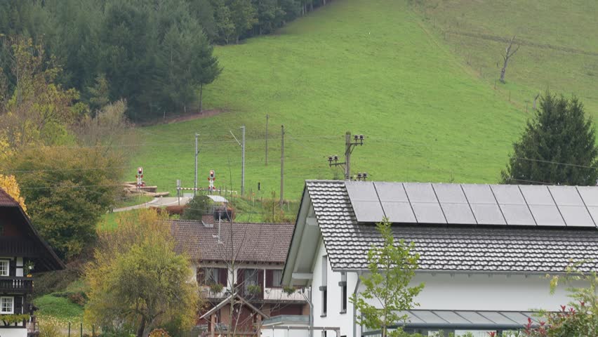Train Traveling Through the Black Forest Near Gengenbach, Germany, Scenic Landscape with Traditional Houses, Hills and Green Meadows