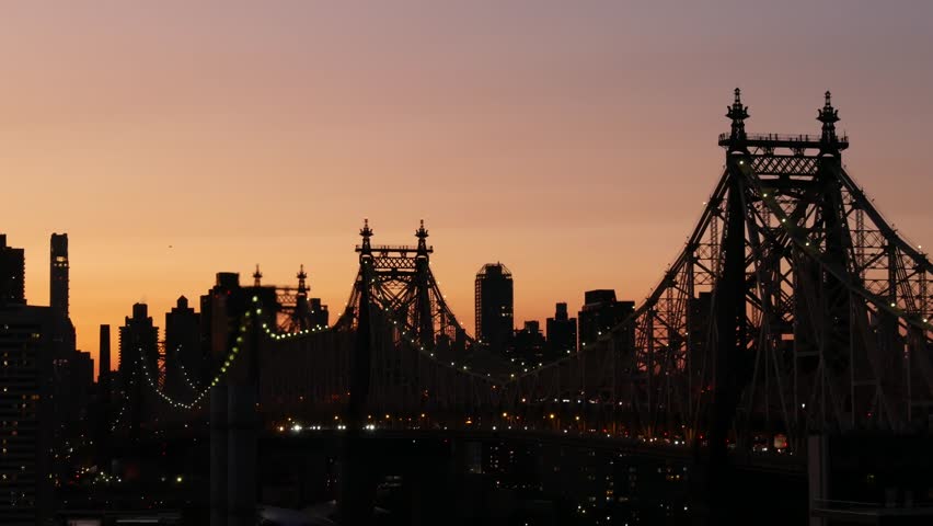 New York City Manhattan Midtown skyline from Queens, Queensboro bridge architecture, United States. Rooftop cityscape from Long Island Hunters Point. Urban sunset twilight dusk dark evening silhouette