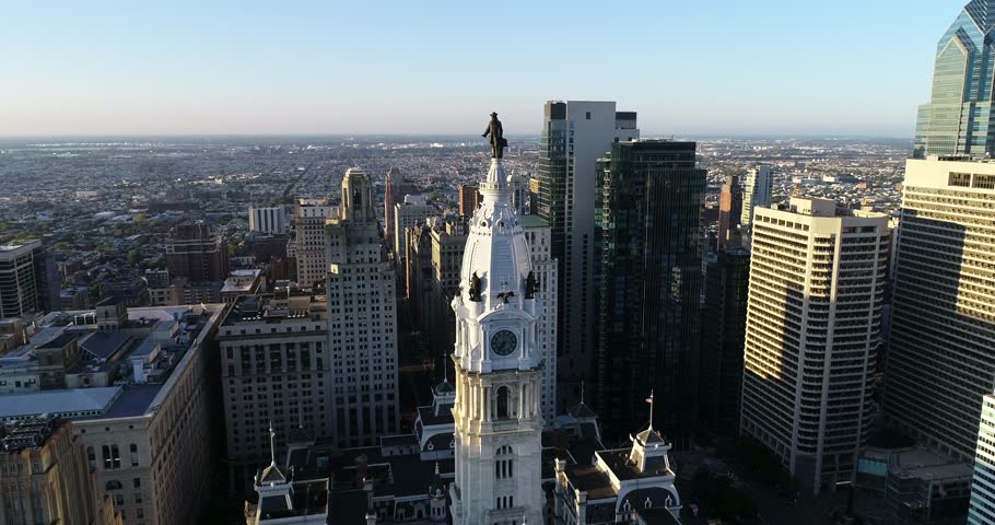 Philadelphia City Hall Tower and bronze statue of William Penn. Cityscape and Beautiful Sunset Light in Background. Pennsylvania 4k