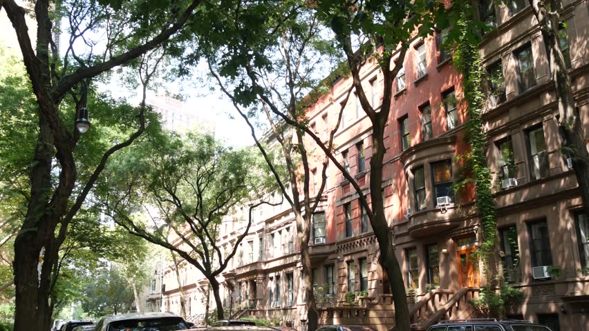 New York City townhouse buildings, brownstone row houses in Manhattan or Brooklyn, United States of America. Classic buildings on residential district street. Real estate property. Rowhouse townhome.
