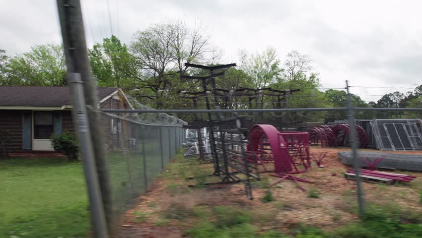 Moving past middle lower class poor neighborhood street homes outside downtown capital city Montgomery, Alabama in historic suburb community with houses, buildings, sidewalk, cars, driveways, and road