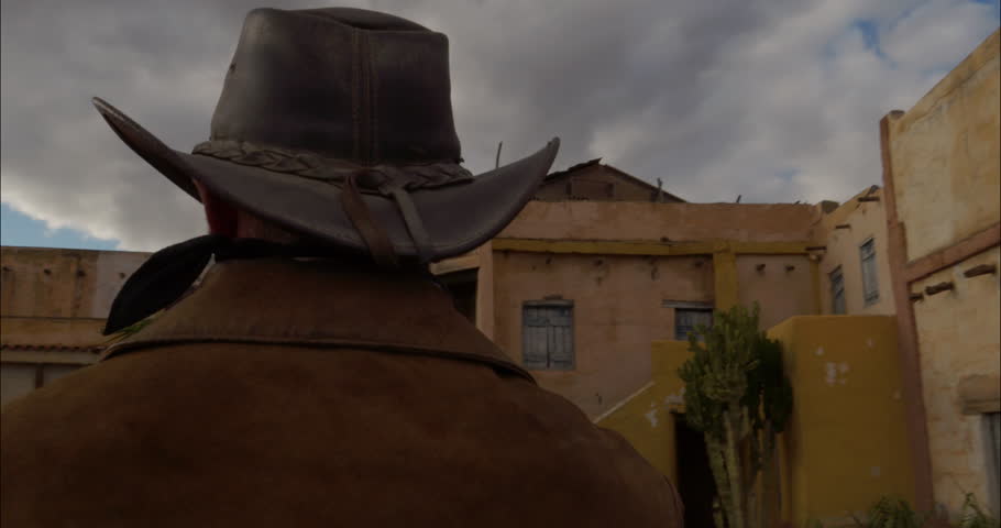 Cowboy riding into an Old West Mexican Town