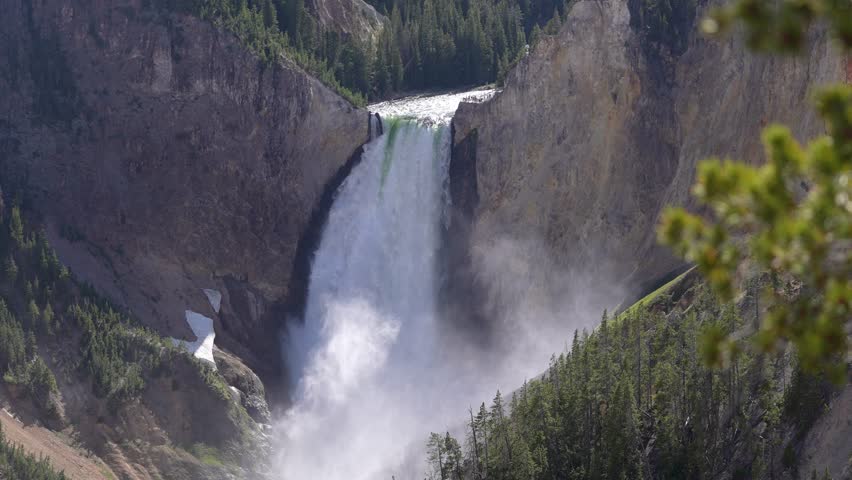 Beautiful shot of the Lower Falls in Yellowstone National Park, Wyoming, showcasing the massive and majestic waterfall surrounded by rugged canyon walls