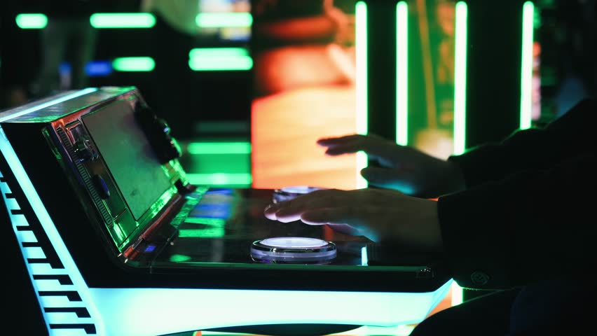 A man is playing slots machine and roulette or poker, gambling in casino close up, game machine in cafe or hotel lobby. Playing betting game.