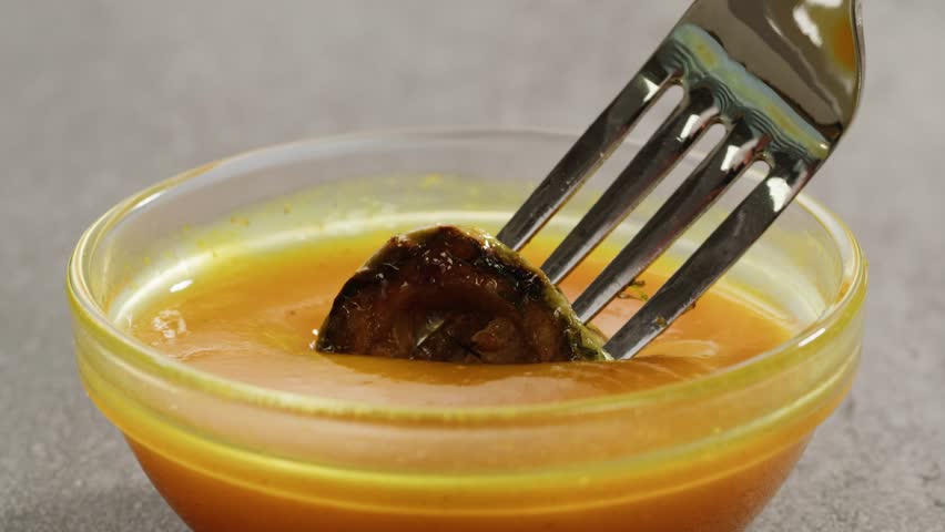 Curry cheese lemon sauce close up, fast food cafe Pouring fries potato and fry chicken in mayo yellow creamy cheese sauce close-up. Eat chicken nuggets with Peruvian sauce. Fast and junk food concept.