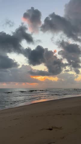 Dramatic sunrise clouds over a tropical beach in Malaysia