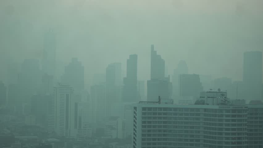Cityscape of Bangkok covered by mixture of dust in air pollution. Heavy air pollution of fine particulate matter (PM2.5) in morning.
