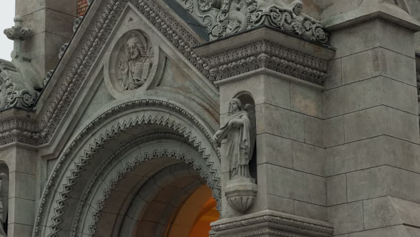 Close-up of ornate stone carvings and religious sculptures on St. Francis of Assisi Parish Church in Budapest, highlighting historic Catholic architecture, craftsmanship, and European heritage details