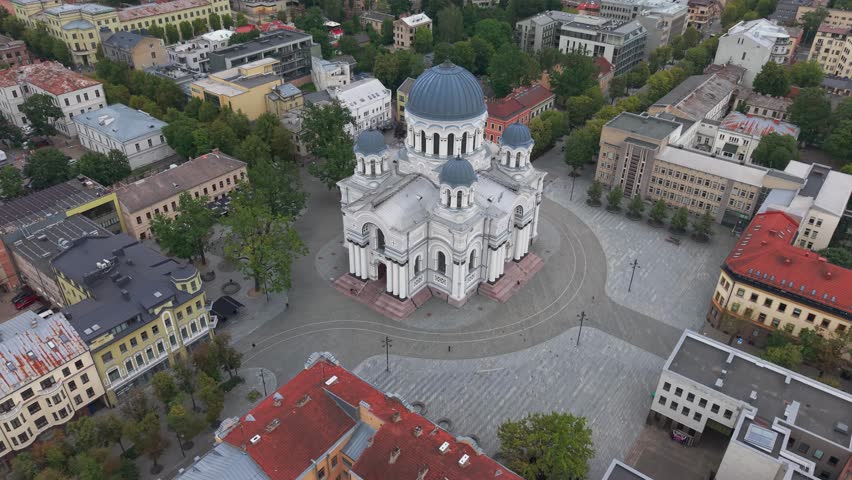Drone footage captures the stunning architecture of St. Michael the Archangel Church in Kaunas, Lithuania. The overhead view showcases the urban landscape in vivid clarity.