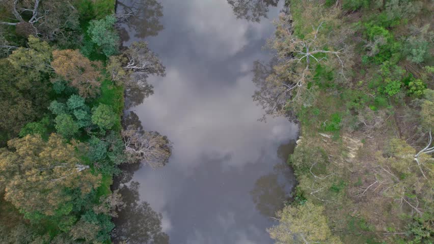 Drone view looking straight down and zooming out over the Yarra River at Studley Park the Melbourne, Victoria, Australia. December 2025