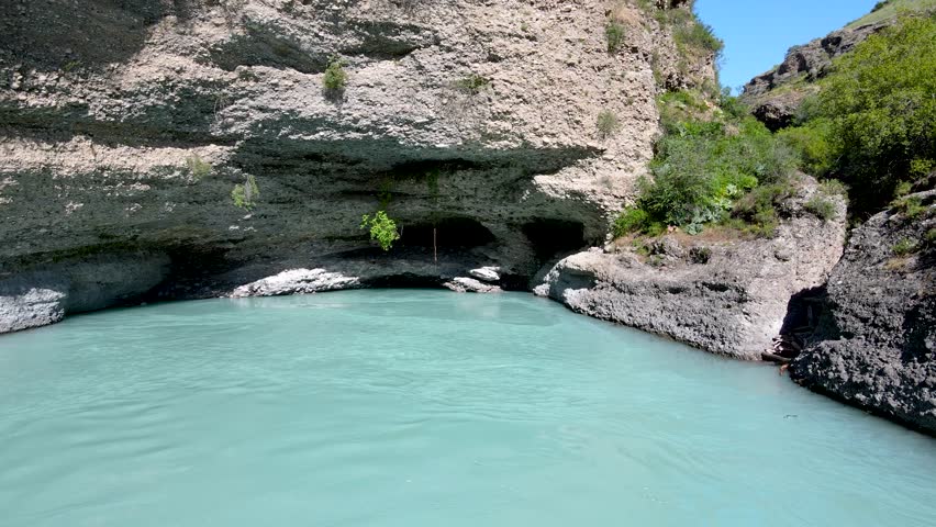 a lake in a stone canyon. a river between rocks.