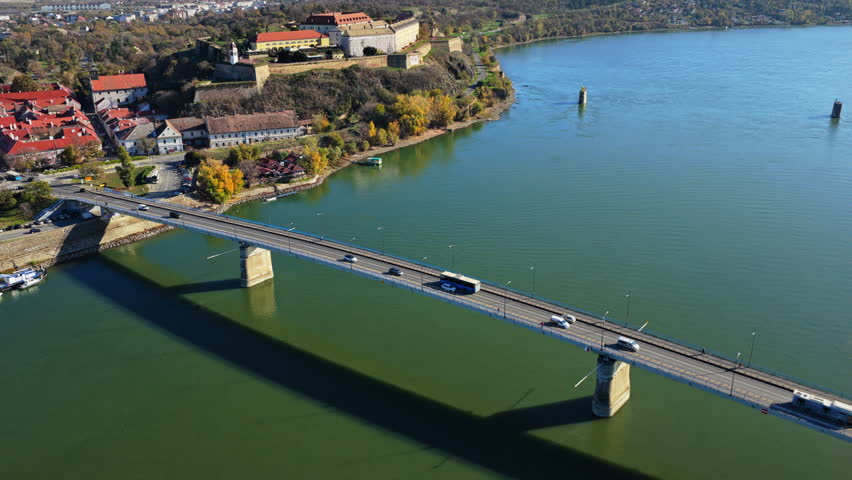 Aerial drone view of Varadin Bridge crossing the Danube River in Novi Sad, Serbia, with Petrovaradin Fortress visible in the background