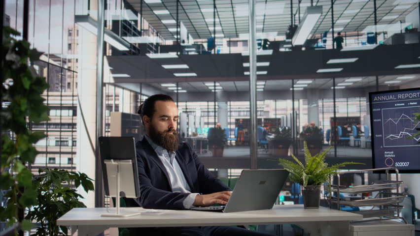 Portrait of professional director sitting at business office with authority, planning company organization success. CEO businessman in modern corporate workplace, office life.
