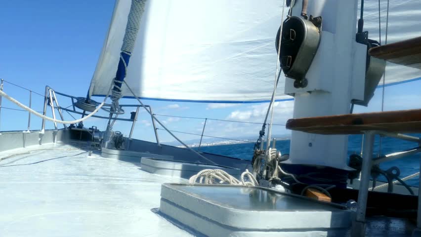 Experience the serenity of sailing on a beautiful yacht across the deep blue ocean, capturing the essence of luxury travel and adventure on the water.