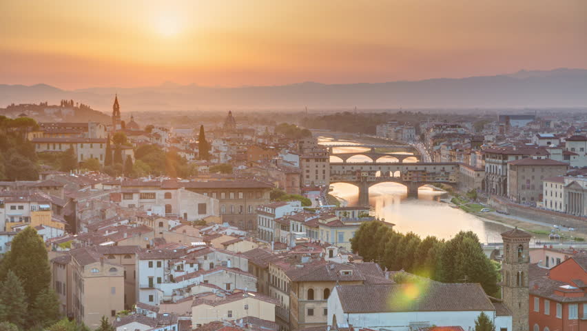 Skyline view of Arno River aerial timelapse from above. Ponte Vecchio from Piazzale Michelangelo at Sunset, Florence, Italy. Colorful sky. Evening mist