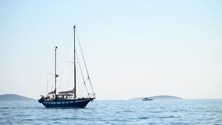 Two masted sailing yacht at sea. Sailing boat on the blue sea. 