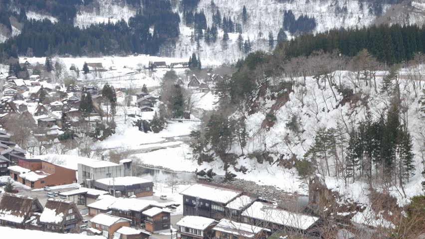 aerial landscape view of shirakawago village among mountain hill range with many gassho zukuri traditional house japanese style with snow covered. Shirakawago village in winter snowy time