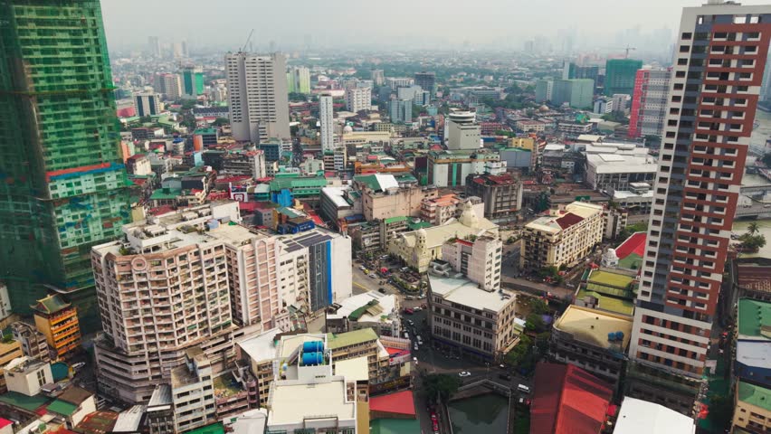 Establishing shot - dense Binondo skyline and colorful city blocks in Manila