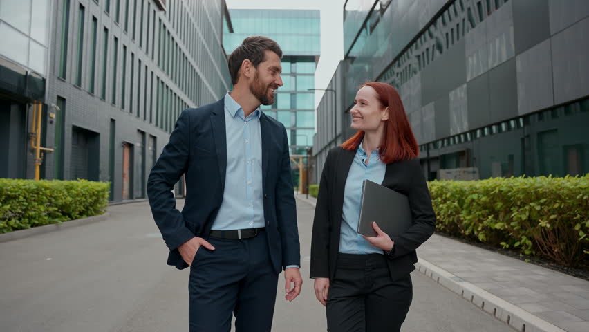 Caucasian confident business woman man looking at camera smiling posing in city successful happy businesspeople hands crossed outdoor office building colleagues coworkers partners female male together