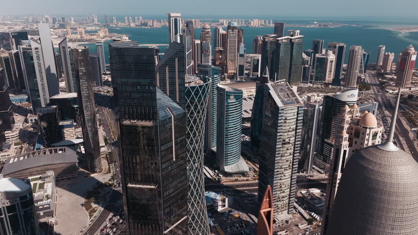 Top down aerial view of the modern skyline of Doha in Qatar on a bright sunny day with iconic skyscrapers and clean city layout
