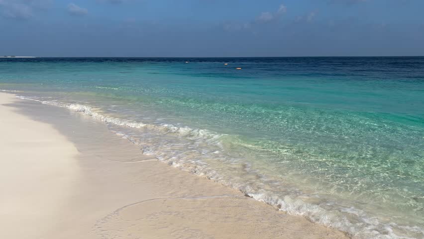 Ukulhas beach Maldives with white sand shoreline and calm turquoise ocean