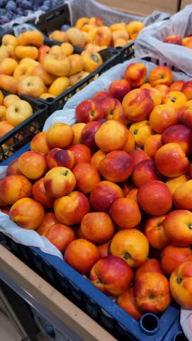 Fresh fruits are arranged at a market with various colors and types on display