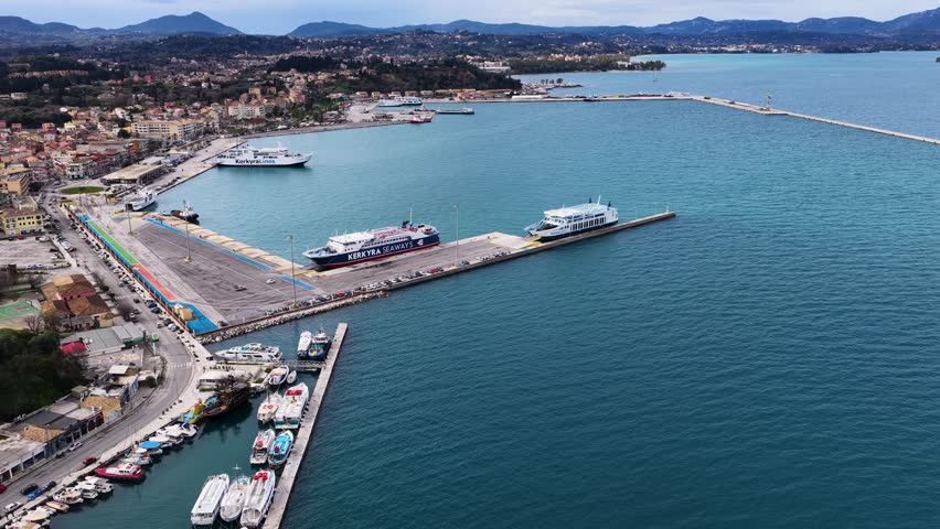 Wide Aerial Shot of Corfu Port with Ferries, Pier and Waiting Vehicles, Greece
