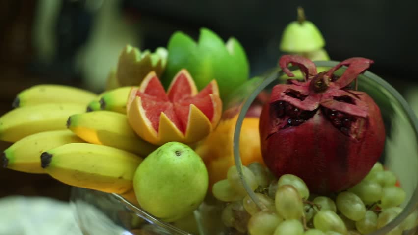 A beautifully arranged buffet table overflowing with a variety of gourmet food, including fruits, cheeses, nuts, mini sandwiches, wraps, and pastries, presented elegantly for a special occasion.