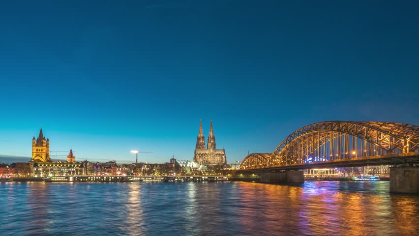 Cologne (Koln) Germany time lapse day to night sunset city skyline at Cologne Cathedral (Cologne Dom) with Rhine River and Hohenzollern Bridge