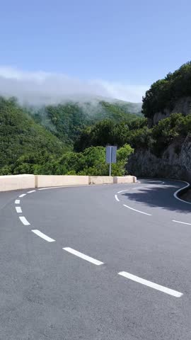 Steep hairpin bend on TF-12 mountain road, Anaga, Tenerife. Camera pans smoothly left to right.