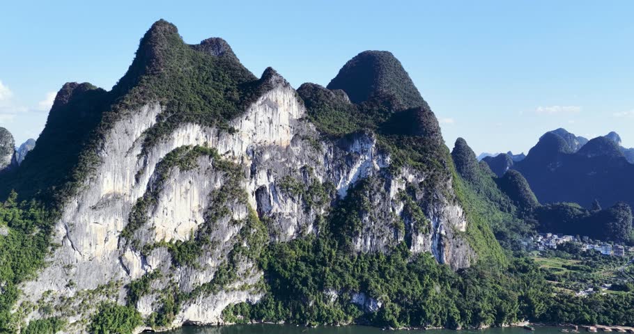 Aerial video close-up of the Nine-Horse Painting Mountain — iconic karst cliffs along the Li River in Yangshuo, Guilin, China