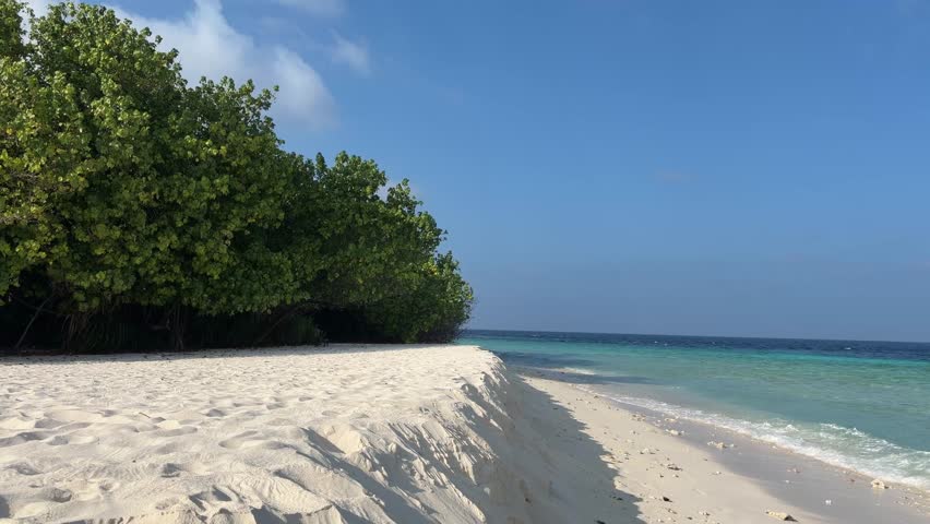 Ukulhas beach Maldives with white sand shoreline and calm turquoise ocean