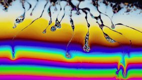 Close-up macro footage of an iridescent soap bubble displaying flowing rainbow light waves and organic liquid forms. Suitable for science education, mindfulness content, luxury visuals, and premium abstract motion design. - Powered by Shutterstock - Get 15% off with code: PIKWIZARD15