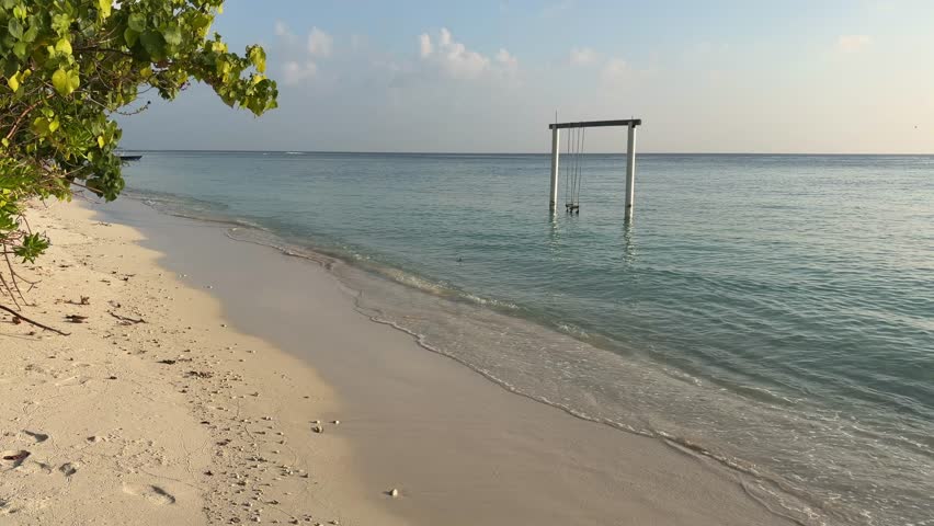 Ukulhas beach Maldives with white sand shoreline and calm turquoise ocean