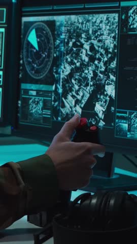 Soldier in a dimly lit military control room, intensely focused on multiple computer screens displaying crucial operational drone data.