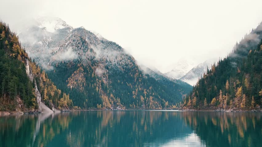 Scenery Jiuzhaigou national park in Sichuan, China. Beautiful Long lake and snow mountain in Autumn season. Famous Landmark and Vacation near Chengdu, China. Asia travel concept