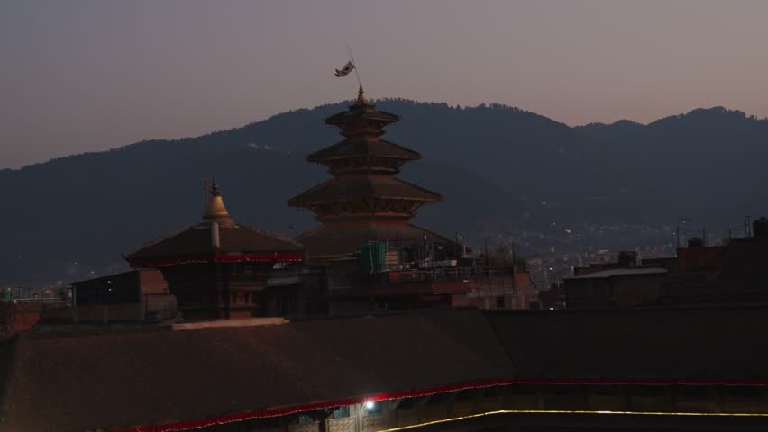 Nyatapola Temple and surrounding shrines illuminated during early evening in historic Bhaktapur, Nepal