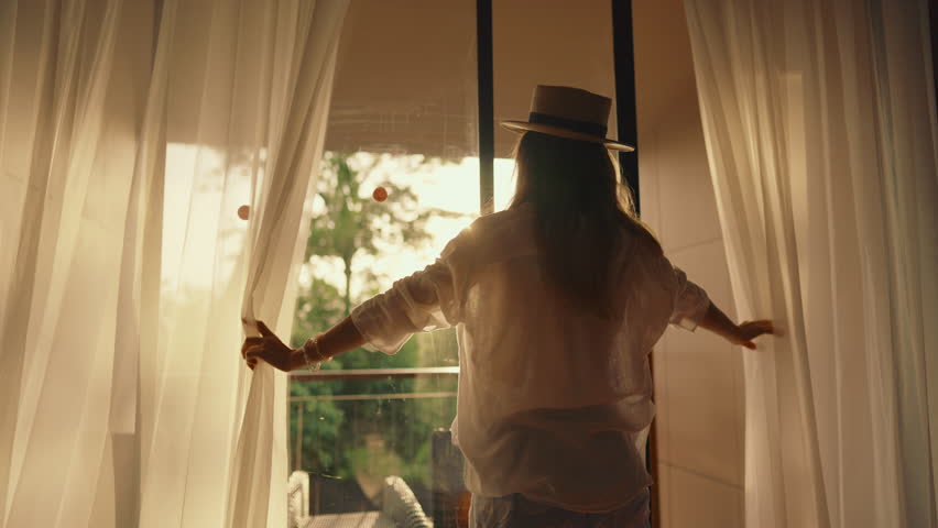 Sunrise Woman Silhouette, Backlit Woman Opening Curtains Amid Tropical Morning Scenery, Serene Early Morning Moment With Flowing Clothing And Golden Sunlight Filtering Through Sheer Curtains