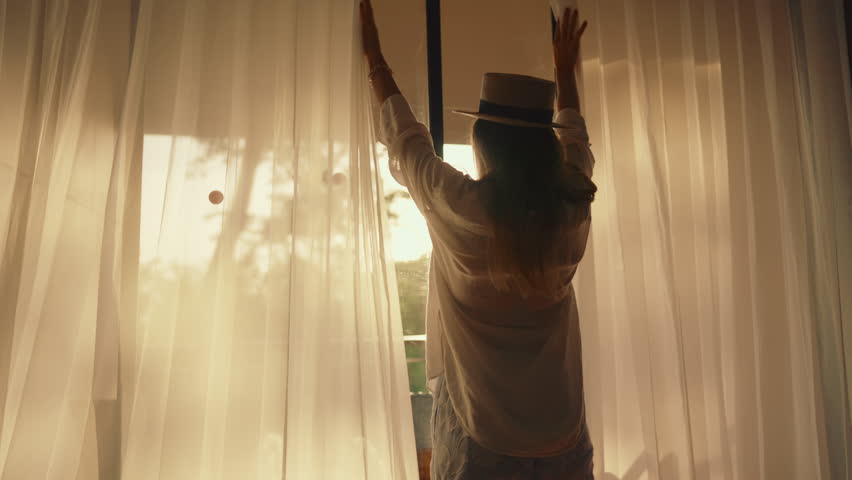 Be happy and enjoy summer, joyful female tourist admiring garden through window. Calmness and solitude in beautiful tropical country, young adult woman enjoying life and moments, single traveler