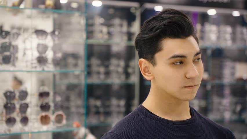 Portrait of a handsome man in an optical store