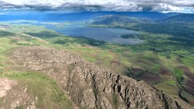Aerial Anatolia Turkey lake, wide valley, treeless mountain ridges, patchwork farmland under clouds. High altitude scene reveals inland waterbody beside green fields, rocky highlands, storm sky. - Powered by Shutterstock - Get 15% off with code: PIKWIZARD15
