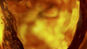Super Slow Motion Shot of Waving Golden Alcohol Liquid Background at 1000fps. - Powered by Shutterstock - Get 15% off with code: PIKWIZARD15