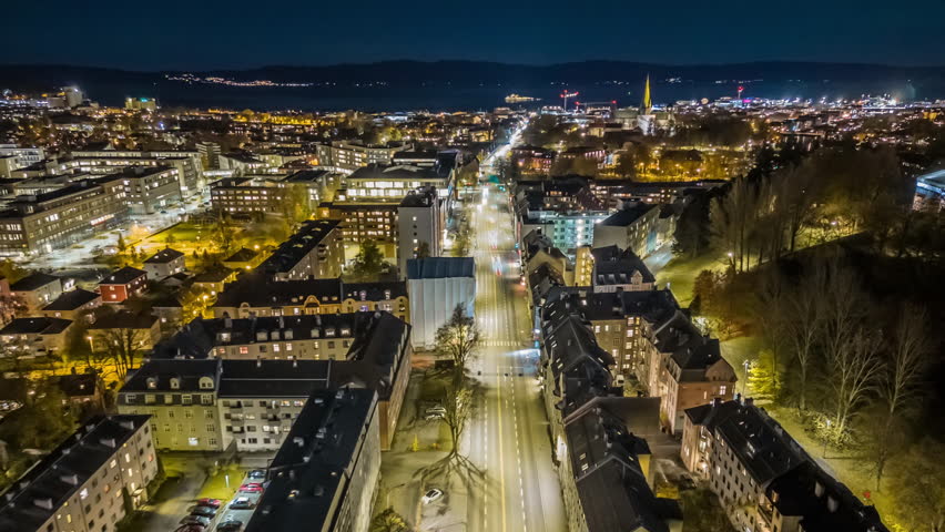 Aerial drone hyperlapse moving forward over Elgeseter gate in Trondheim, Norway, approaching Nidaros Cathedral in the evening. Smooth stabilized moving timelapse footage captured in 4K UHD 25 fps