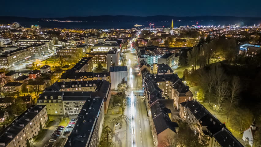 Aerial drone hyperlapse moving forward over Elgeseter gate in Trondheim, Norway, approaching Nidaros Cathedral in the evening. Smooth stabilized moving timelapse footage captured in 4K UHD 30 fps