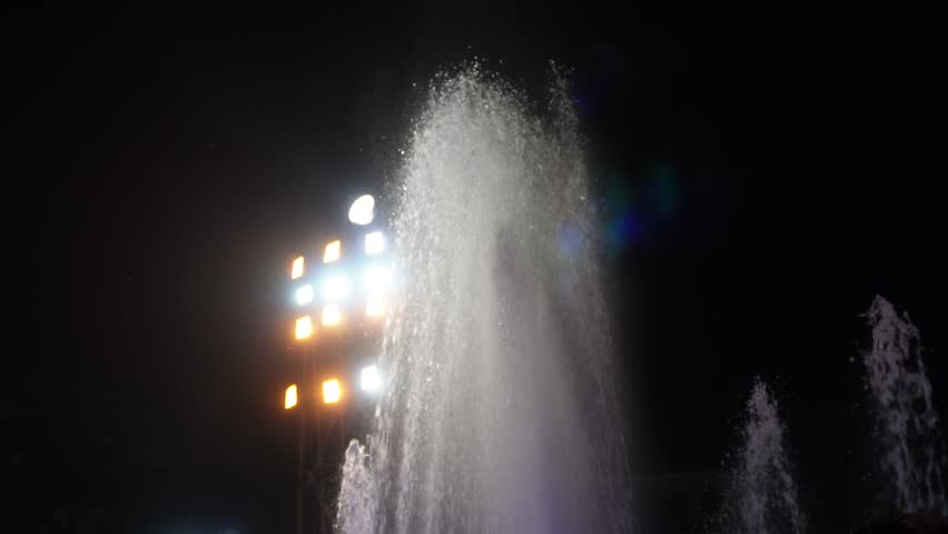 Musical water fountain shows at night synchronize water jets